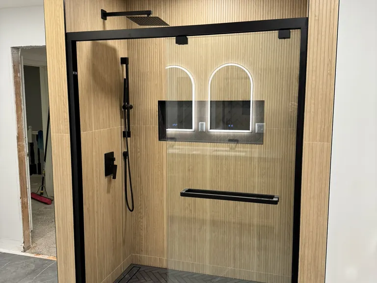 The finished shower: a fixed head and a handheld on a slide bar.