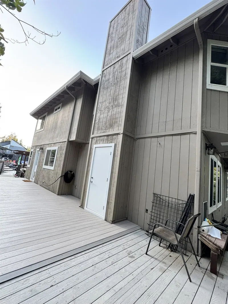 New composite deck along the back of a two-story house